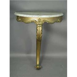 A carved wood and gold painted console table with a demi-lune white marble top on a single scrolled 