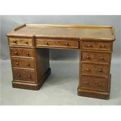 A Victorian mahogany pedestal desk with recessed top