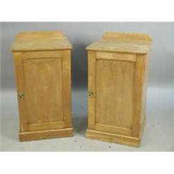 A pair of Maple & Co. oak pot cupboards each with a single panelled door