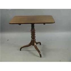 A Victorian mahogany tripod table with a rectangular snap top
