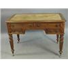 Image 1 : A Victorian oak kneehole writing table with four drawers on turned and reeded legs