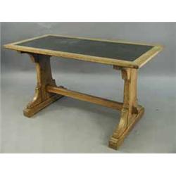 A Victorian oak refectory table with writing inset over standard end supports