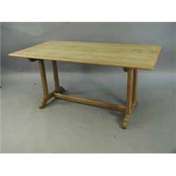 An Arts and Crafts oak refectory table with a plank top on square chamfered end supports
