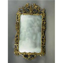 A late 19th century carved wood and gilt wall mirror
