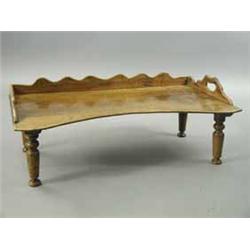 A Victorian walnut bedtable with a wavy gallery