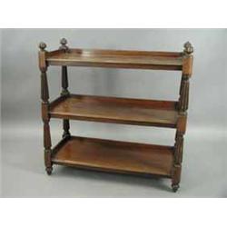 A Victorian mahogany three tier buffet on turned and reeded supports