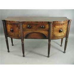 A good George III strung mahogany bow fronted sideboard with two frieze drawers flanked by a celaret