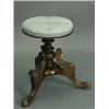 Image 1 : A Victorian walnut revolving piano stool with a carved frame and an upholstered seat Est.250/30