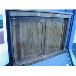 A Victorian rosewood side cabinet with two panelled doors within turned columns Est.300/50