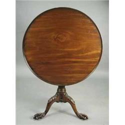 A good George III Irish mahogany tripod table having a single piece circular dished top over a stop 