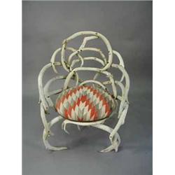 A Victorian antler elbow chair with a cushion seat covered by a North American Indian (?) tapestry s