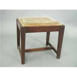 A George III mahogany stool with a drop in upholstered seat and moulded legs