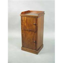 A 19th century mahogany two door pot cupboard raised on a plinth base