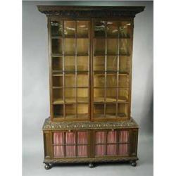 A good Pepysian oak bookcase having an acanthus moulded cornice over two astragal glazed doors.  The