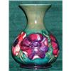 Image 1 : A Moorcroft "Pansy" pattern baluster form vase on a green ground, height 15.5cm