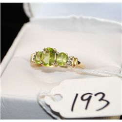 WOMENS PERIDOT AND DIAMOND RING WITH THREE  PERIDOT AND FOUR DIAMONDS - SET IN 10K YELLOW  GOLD RING