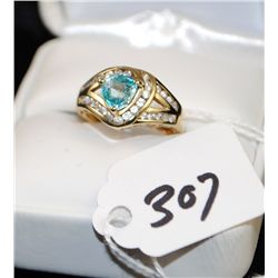 FANCY LADIES BLUE TOPAZ AND CZ RING WITH ONE  TRI-CUT BLUE TOPAZ AND SURROUND WITH CZ  ACCENTS STONE