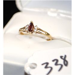 WOMANS GARNET AND DIAMOND RING WITH ONE  MARQUISE CUT GARNET CENTER GEMSTONE AND FOUR  ACCENT DIAMON