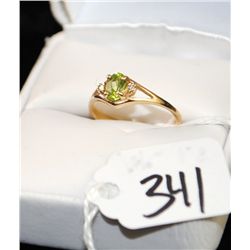 LADIES PERIDOT AND DIAMOND RING WITH ONE OVAL  PERIDOT CENTER GEMSTONE AND TWO ACCENT  DIAMONDS SET 