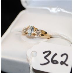 LADIES BLUE TOPAZ AND DIAMOND RING WITH ONE  OVAL CUT BLUE TOPAZ AND TWO ACCENT DIAMONDS  SET IN 10K