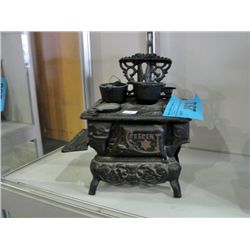 Cast metal cresent toy stove