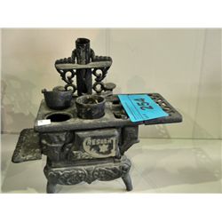 Cast metal cresent toy stove