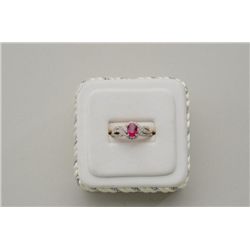 One ladies ring in two tone 14k  gold set  with a oval ruby approx 1.5ct and diamonds  weighing 0.24