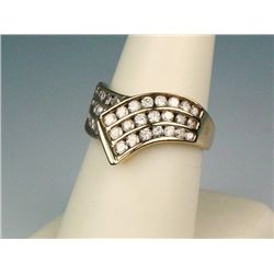 Dazzling 10 karat yellow gold ladies ring  channel set with 35 round diamonds weighing  approx. 1.00