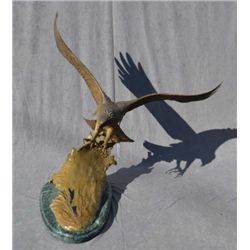 Original bronze casting of Eagle swooping in  on salmon and water by Doug Van Howd numbered   1 of o