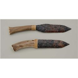 Lot of 2 modern made stone blade knives  secured to antler grips by rawhide wraps,  both approx. 12”