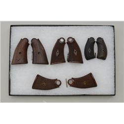 Lot of 4 pair of Smith & Wesson revolver  grips including a pair of checkered wood  medallion grips 