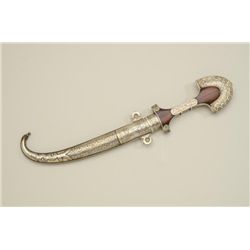 Older mid-eastern type curved blade knife  with ornamented wood grip and matching  ornamented sheath