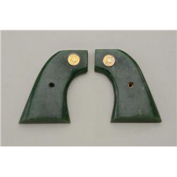 Green Onyx of Jade medallion grips for a Colt  SAA in very good condition.  Est.:   $250-$500.