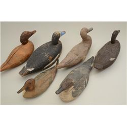 Group of 6 older duck decoys, 4 carved wooden  and two canvas; one of the canvas decoys has  glass e