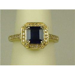 Intricate 14 karat yellow gold ladies ring  set with a square blue sapphire weighing  approx. 1.50 c