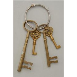 Lot of 4 brass reproduction jail lock keys on  a large ring.  Est.:  $15-$30.