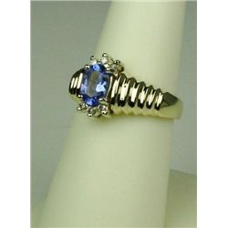 Stylish 14 karat yellow gold ladies ribbed  design ring set with an oval Tanzanite  weighing approx.