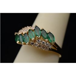Colorful 14 karat yellow gold ladies ring set  with 7 MQ cut fern green emeralds weighing  approx. 1