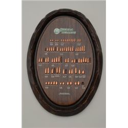 Sierra Bullet advertising board with various  caliber identified bullets, wood grained  plastic boar