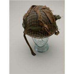 WW II U.S. M1 Helmet and liner with chin  strap, camo netting and material strips; in  overall very 