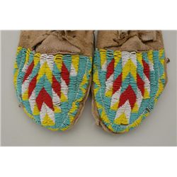 Pair of beaded moccasins, possibly Sioux,  yellow, red, white and light blue beadwork,  some slight 