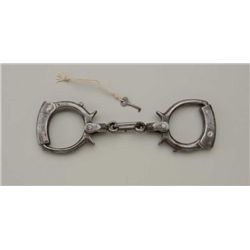 Cumming handcuffs with key in overall very  good condition; a hard-to-find maker and  desirable to c