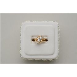 One 14k yellow gold ladies ring set with a  marquee diamond weighing approx. 0.75ct and 6  side diam
