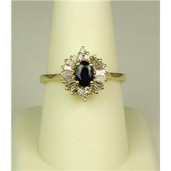 Exquisite 14 karat yellow gold ladies  ballerina design ring set with a center  cobalt blue sapphire