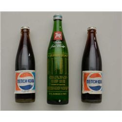 Lot of 3 bottles of soda including two full  older Pepsi bottles in Russian and a 7-UP  Commemorativ