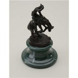 Miniature bronze copy of Frederic Remington’s  cowboy on bucking bronco on base, approx. 6”  in heig