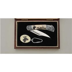 Stainless steel folding pocket knife by Fury  with etched mountings and game scene design  on one si