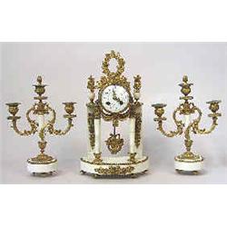 A three-piece garniture white marble, 19 th century, signed MC on top, clocks h 38 cm 6.000-8.000...