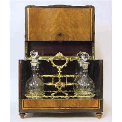 A tantalus 19 th century, with 3 decanters, h 28 cm; decanters not original 2.000-3.000...