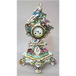 A mantle clock porcelain, Rörstrand, Sweden, turn of the century, höjd 55 cm; damages 12.000-15.000.